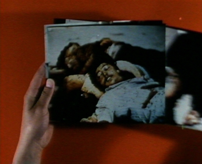 Israeli POWs view photographs from Sabra and Shatila. Still from Massacre: Sabra and Shatila, 1982, Kassem Hawal. Courtesy of the artist.  